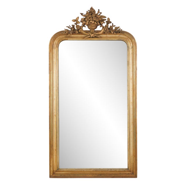 Antique French Louis Philippe giltwood mirror with a foliate urn motif. It features the rounded upper corners paired with...
