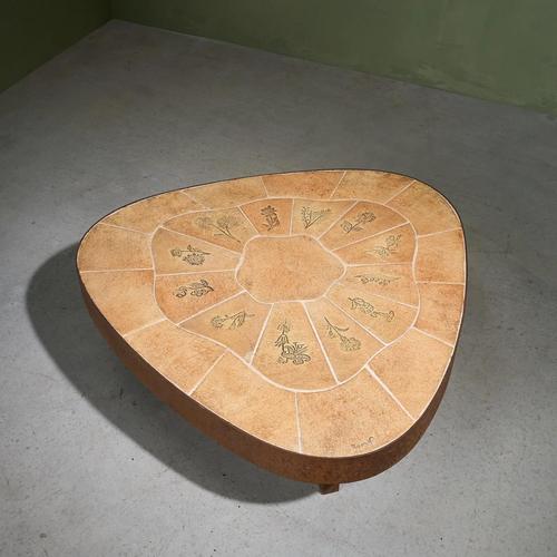 This organic-shaped coffee table, designed by Barrois in the 1960s, features a ceramic tile top with a flower pattern and...