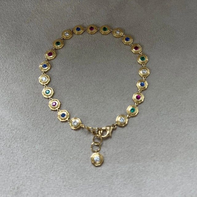 Created in 18 karat yellow gold Emeralds 0.50 carat approx. Rubies 0.65 carat approx. Blue Sapphires 0.65 carat approx....