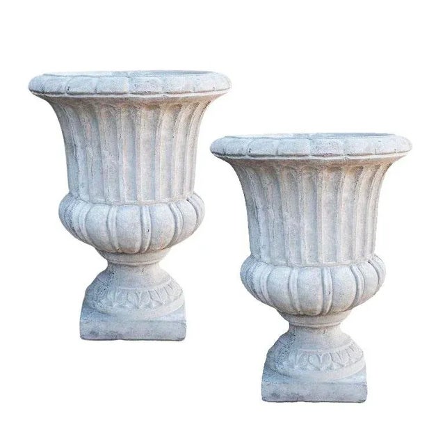 A set of two large rustic French concrete garden planters. This pair of garden planters sit upon square concrete bases....
