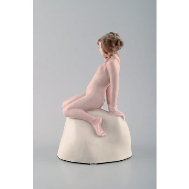 Vicken von Post for Rörstrand, Rare art deco figure in porcelain. Young nude woman on stone. ca. 1920. Stamp: Rörstrand in...