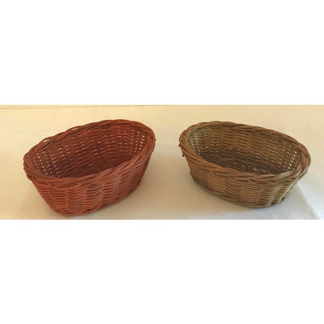 Vintage small oval baskets - one is orange one one is yellow. And they do nest!