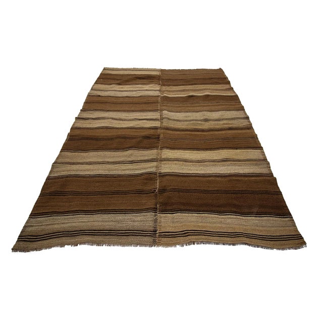 Brown handwoven vintage kilim rug from Kars region of Turkey. Approximately 50-60 years old. In very good condition