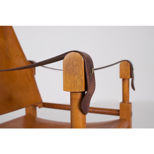 Safari armchair by Wilhelm Kienzle, Swiss manufacturer Wohnbedarf, early 1950s. Light oak frame, seat, back, and armrests...