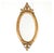 An antique Louis XVI style oval gilt wood wall mirror with a broad, stepped and molded rubbed gold frame with naturalistic...