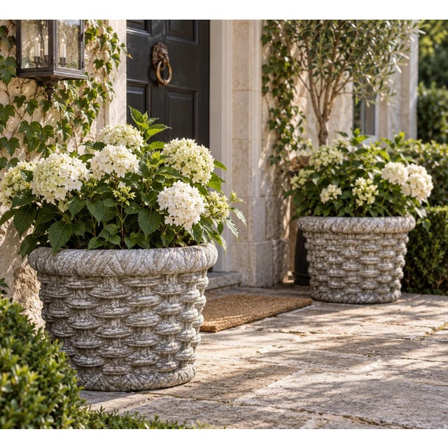 A beautifully weathered pair of vintage cast concrete planters featuring an exceptionally detailed trompe-l'œil...