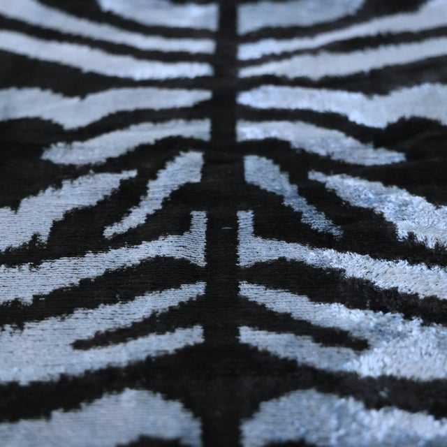 "Bold yet sophisticated, this handmade silk velvet throw pillow reinterprets the timeless beauty of zebra-inspired motifs...