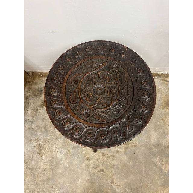 19th century English oak tripod table of exceptional character and craftsmanship. The circular top is beautifully carved...