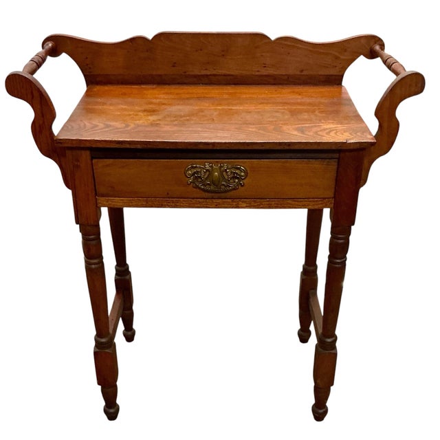 Antique Wood Washstand Side Table With Single Drawer. Handsome brass pull. Legs are connected with a stretcher front to...
