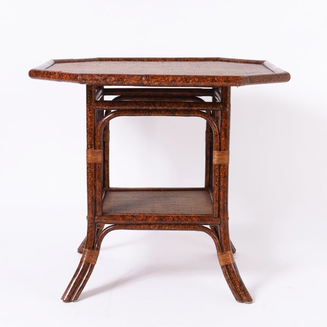Handsome British Colonial style mid century table crafted in faux bamboo with a faux tortoise finish having an octagon...