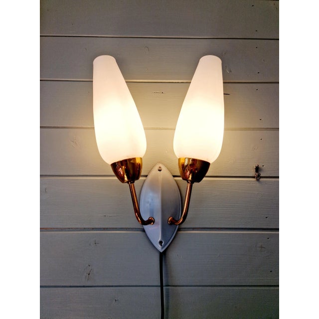 Vintage double wall sconce in brass and gray lacquered metal with two white opaline bobeches, 1950s-60s. It is compatible...