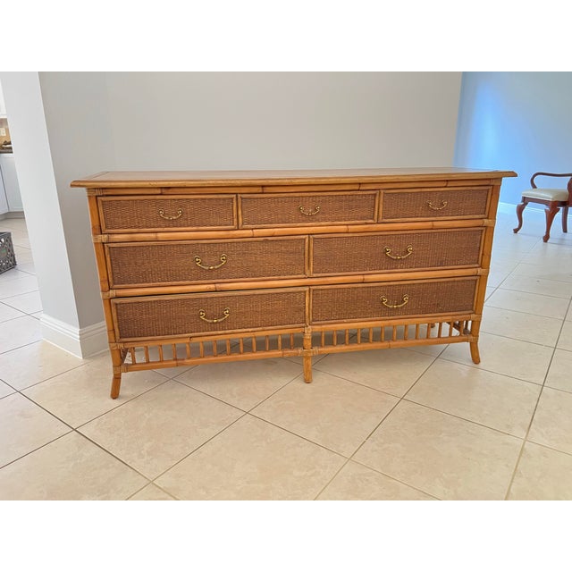 Vintage Bamboo and wicker dresser or it could be used as a buffet. Measures 18” x62” and stands 32” tall. 7 drawers roll...