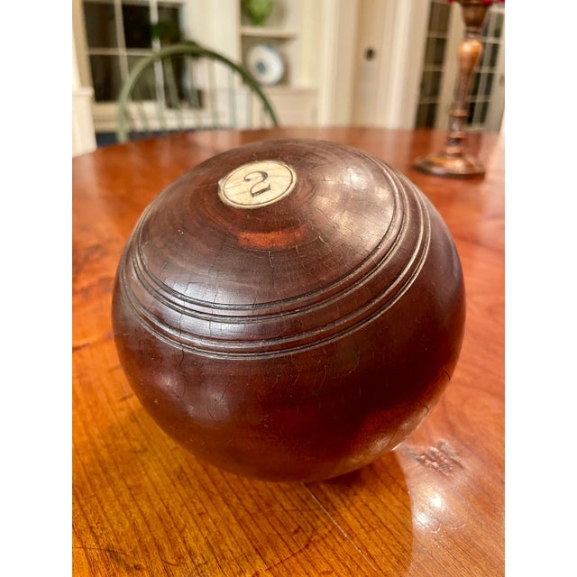 A handsome and unique object to add interest to your home. Solid mahogany ball with an inlaid number two. Origin is...