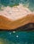 Original 2025 landscape painting signed “L. Romo ’25” at the lower right. This colorful scene depicts a small lakeside...