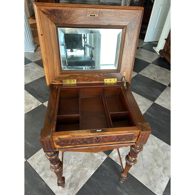 This elegant 19th-century European sewing or dressing table represents the transitional design period between the...