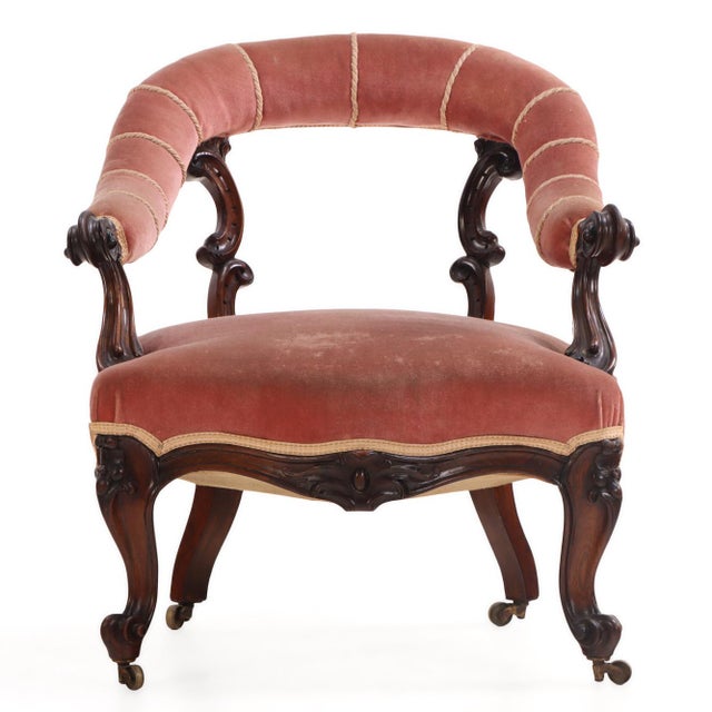exhibiting elegant mid-nineteenth-century craftsmanship and refined proportions. The chair features an upholstered crest...