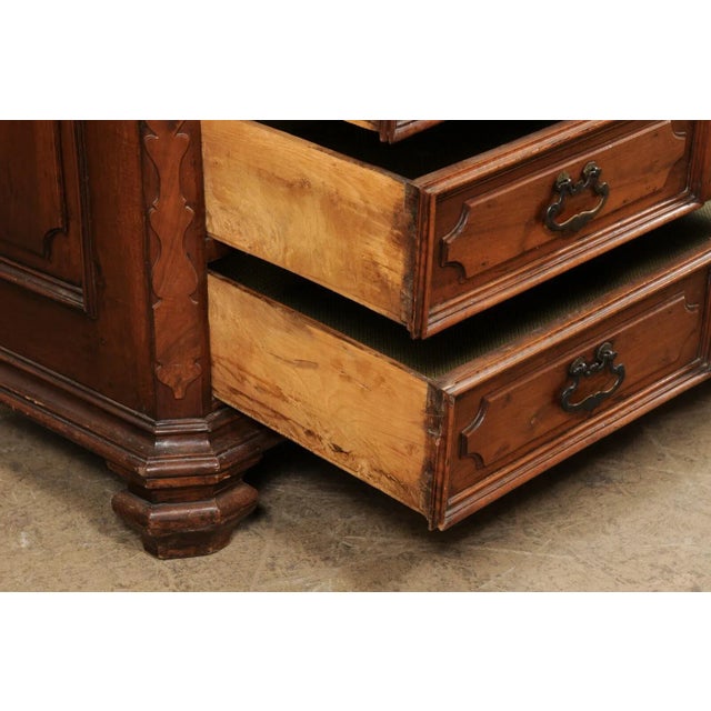 An Italian walnut chest of drawers from the 18th century. This antique cassettiera (chest of drawers) from Italy features...