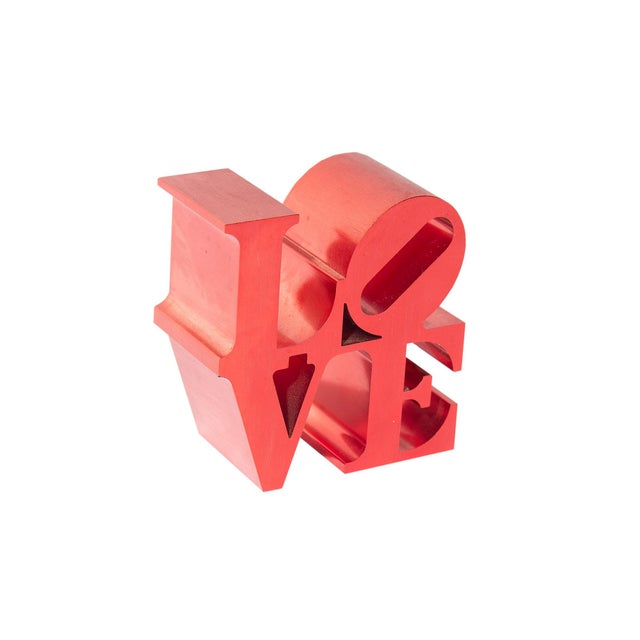 A red LOVE paperweight. This paperweight is based on the sculpture LOVE by American artist Robert Indiana (1928-2018). The...