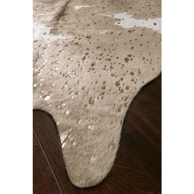A compelling variant of the timeless cowhide rug, the Bryce Collection touts rich metallic accents set against versatile...