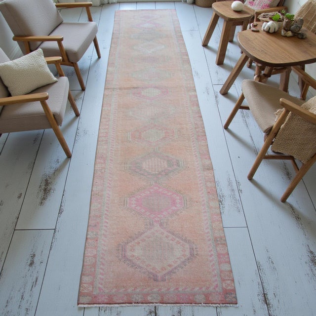 This authentic mid-20th century runner, hand-knotted in Southeastern Anatolia during the 1960s, exemplifies the quiet...
