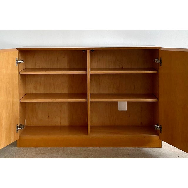 This striking two-piece modular credenza is a masterclass in mid-century minimalist design, offering an expansive and...