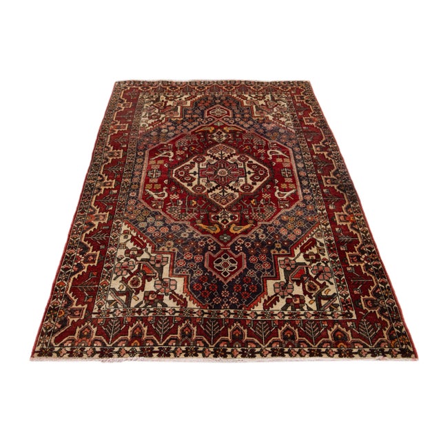 Beautiful vintage hand-knotted Bakhtiari wool rug with red field and multicolor accents all over the motif. This rug...