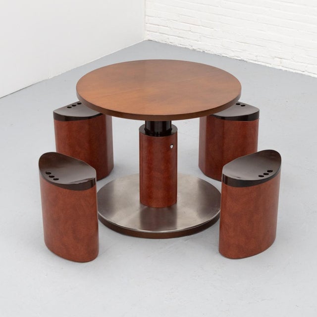 Rare Italian dining set from the 1960s / 70s with a round table and four matching stools. The ingenious design features a...
