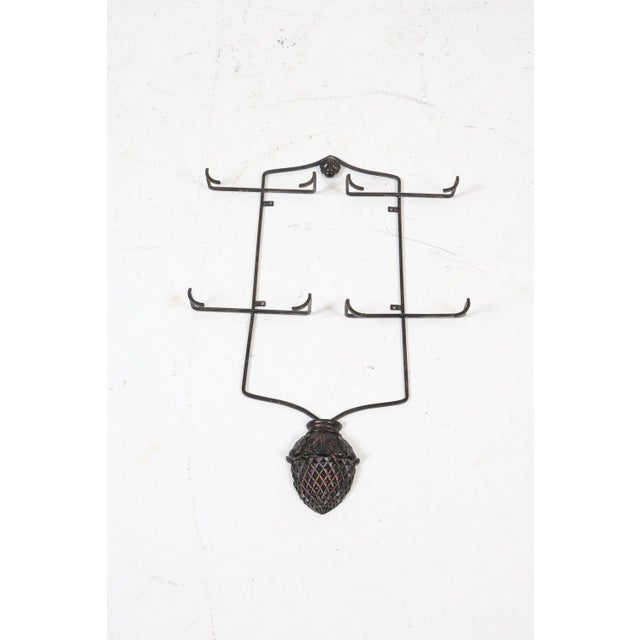 This is an iron vertical plate display rack, primarily used for showcasing decorative collector plates on a wall...