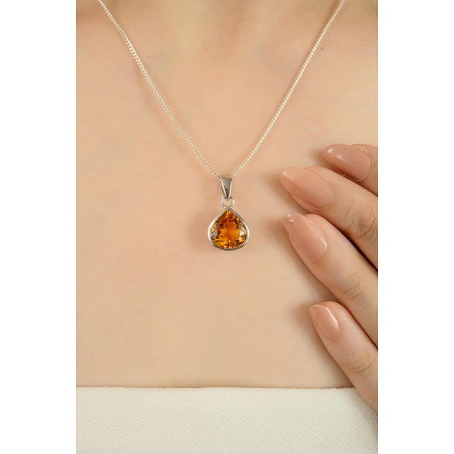This elegant pendant features a natural 3.95 ct Citrine gemstone in a faceted pear shape, measuring 10x8 mm. Set in...