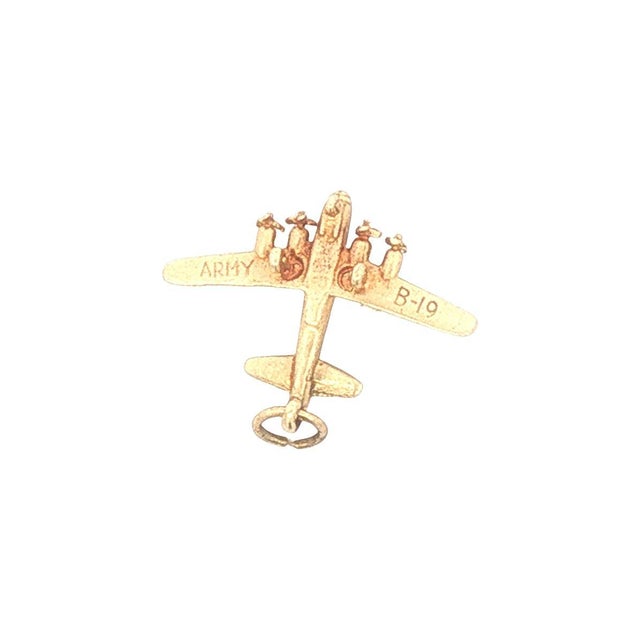 A 14k yellow gold airplane charm. This is a detailed piece in good condition. The wings are engraved Army B-19. It...