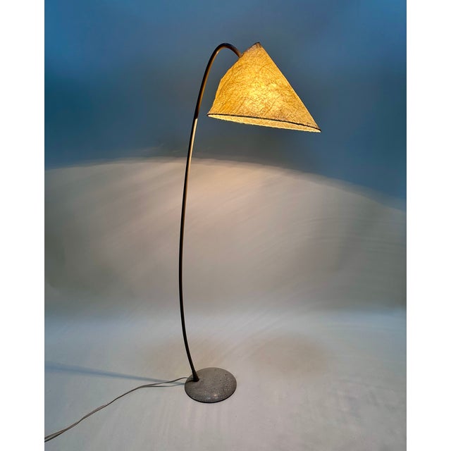 This shapely floor lamp is a rare find, manufactured in the early 1950s in germany. It features a brass metal arc with a...