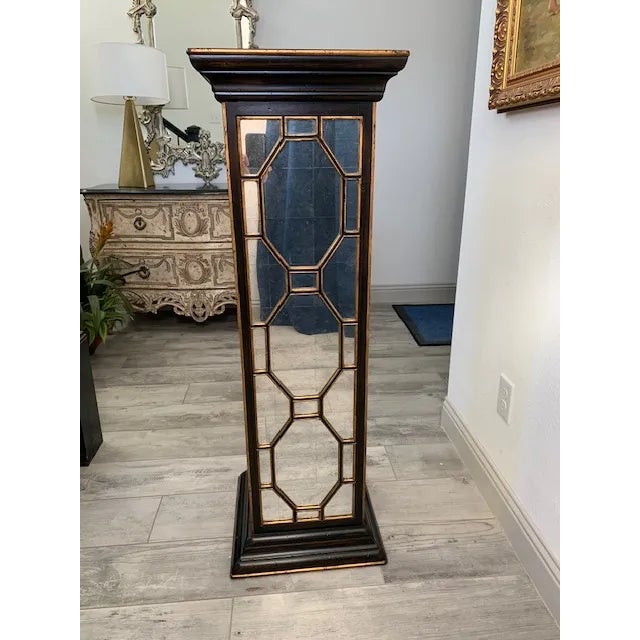 This elegant ebonized pedestal features rich gilded accents, adding a touch of opulence and refinement. The pedestal is...