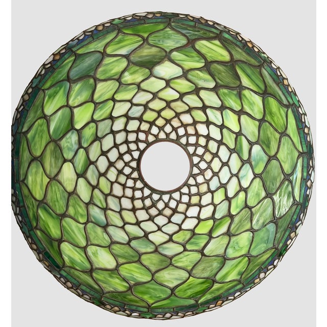 A rare leaded glass lamp shade manufactured by Duffner & Kimberly. The main color of the glass is different shades of...