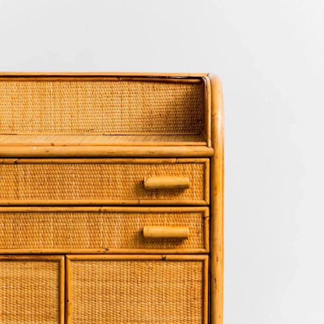 70s entrance furniture. Wooden structure. Details in bamboo and rattan. It has 2 drawers and 2 doors with shelf. Excellent...