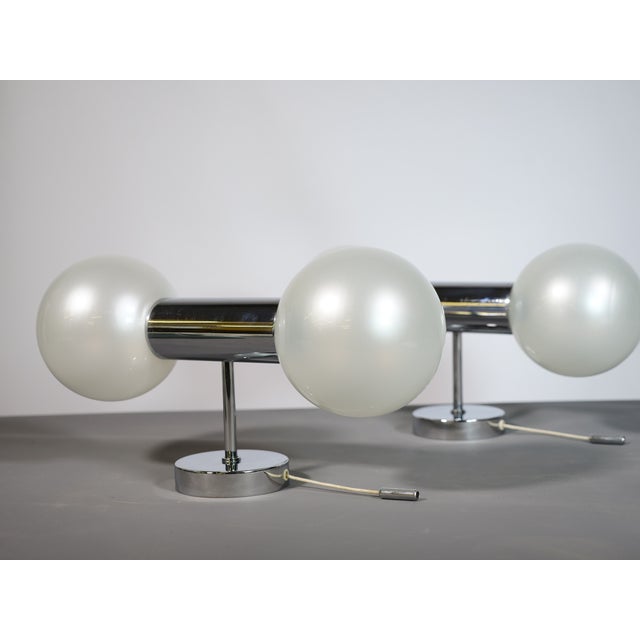 Two space-age wall lamps by Motoko Ishii for Staff Lighting, Germany, from the 1970s. Chrome-plated wall lamps with...