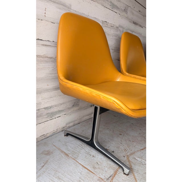 Original vintage Mid Century Modern Bench. Three seats, all connected by black metal and chrome legs. Mustard yellow vinyl...
