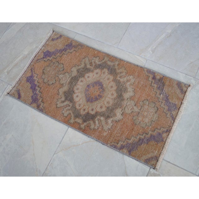 This hand knotted vintage Turkish distressed small rug would be perfect for an entryway, a powder bath or in front of the...