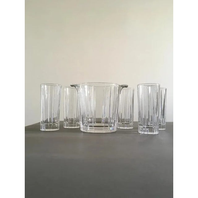 This exquisite set of 5 clear bar glasses with its ice bucket, epitomized the Italian style of this era. The lined surface...