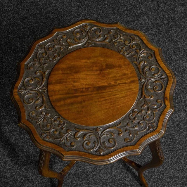 A beautiful Late Victorian mahogany window table with a superb border of foliate carving. The scroll shaped legs are...