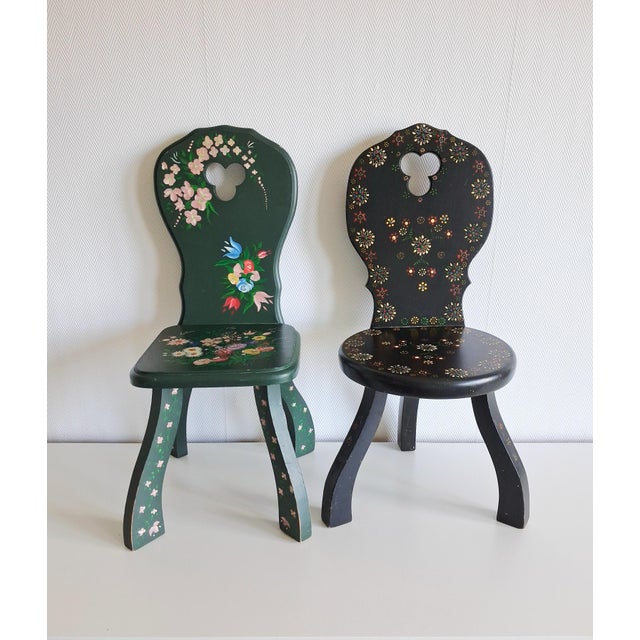 Charming pair of vintage hand-painted wooden children’s chairs featuring beautifully detailed folk art floral decoration...