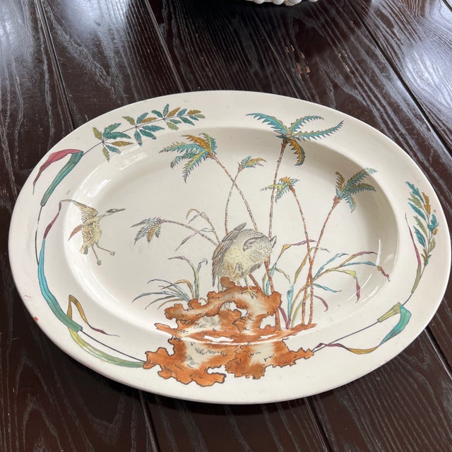 A large polychrome transfer ware serving platter from Copeland in 1877. This piece is decorated with colorful palms and...