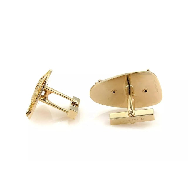 This is an authentic pair of vintage cufflinks from Tiffany & Co. They are crafted from solid 14k yellow gold. The pebble...