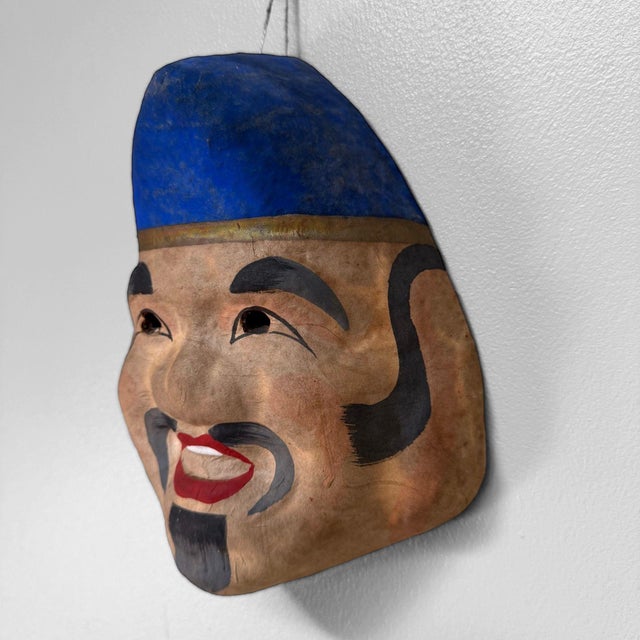 Decorative Japanese papier-mâché mask, dating from the 1950s–1960s. The mask represents Ebisu, or Ebisu-sama, one of the...
