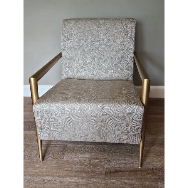 Contemporary bronze arms create the framework of this sculptural, minimalist lounge chair. The seat is slightly pitched to...