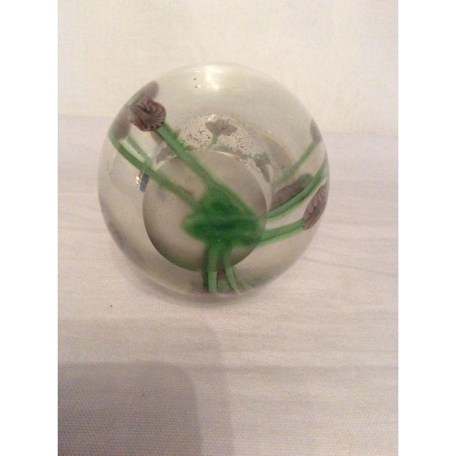 Lovely heavy art glass vase with a lavender and green floral motif. 7” tall