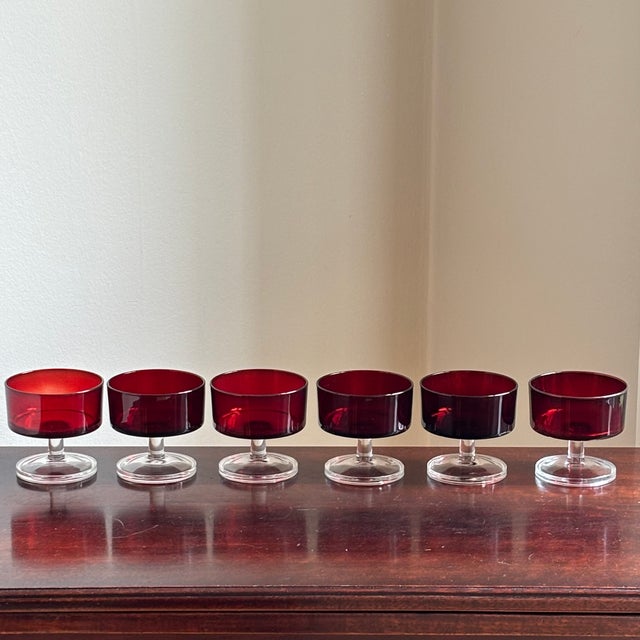 A beautiful set of six vintage French ruby red coupe glasses by Luminarc. These elegant stemmed glasses feature deep...
