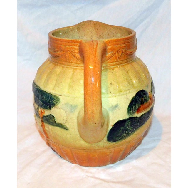 Roseville yellowware pitcher featuring trees and a landscape scene, c. 1910-1916. Unmarked, as is expected with this pattern