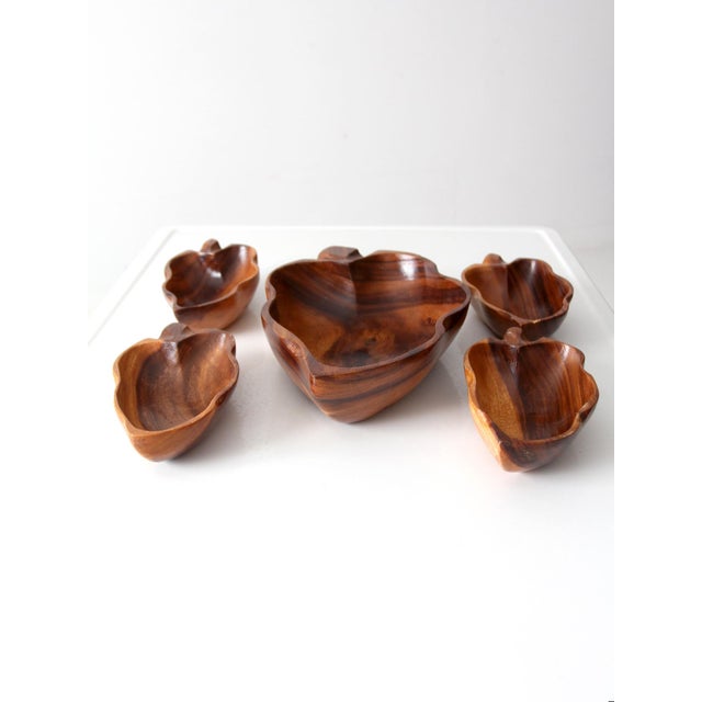 This is a set of mid 20th century vintage wood serving bowls. Shaped as leaves, the figurative wooden bowls include a...