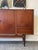 A standout Danish modern teak sideboard by Ejvind A. Johansson, designed to anchor a space with warmth and presence. Rich...