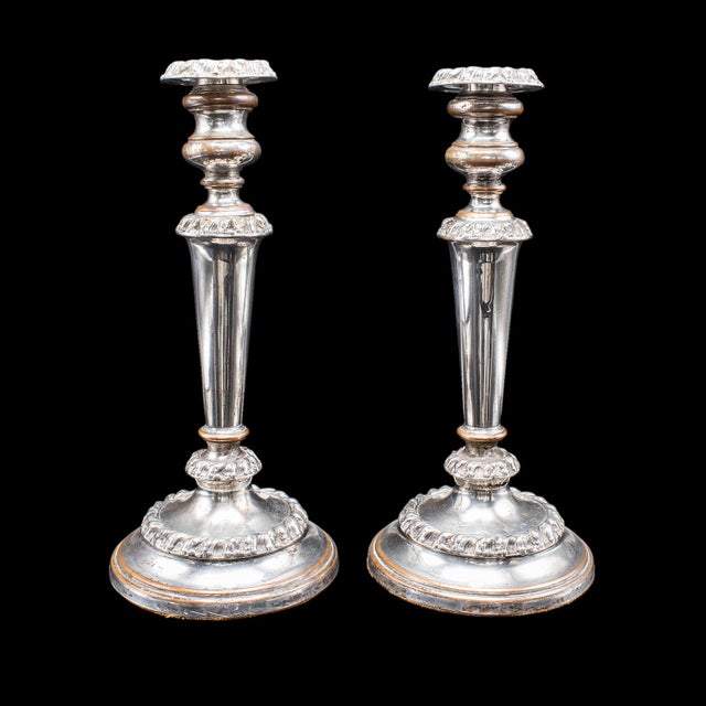 This is an pair of antique Old Sheffield Plate candlesticks. An English, silver plated candle nozzle, dating to the...